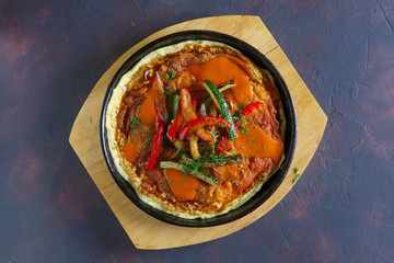 Top view of omelette with paprika and zucchini. Rural breakfast.