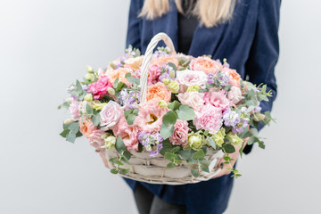 Beautiful spring bouquet in wicker basket. Arrangement with various flowers. The concept of a flower shop. A set of photos for a site or catalogue. Work florist.
