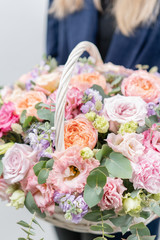 Beautiful spring bouquet in wicker basket. Arrangement with various flowers. The concept of a flower shop. A set of photos for a site or catalogue. Work florist.
