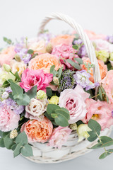 Beautiful spring bouquet in wicker basket. Arrangement with various flowers. The concept of a flower shop. A set of photos for a site or catalogue. Work florist.