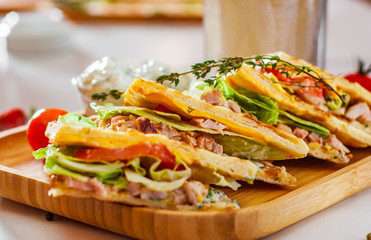 Skepasti: pork gyros with meat, tzatziki sauce, vegetables, cheese and french fries on wooden plate