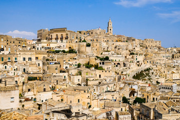 Fototapeta na wymiar Sassi di Matera. Panoramic view for beautiful medieval city of the caves in sunny day.