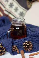 Autumn still life. cup of tea, Scarf and cinnamon sticks on wooden background.