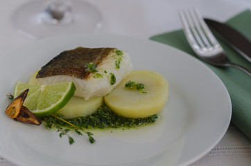 Fresh cod fish with potatoes on the pate in the restaurant. This  popular dish called  bacalhau a braga  in  Portugal and Bacalao a la gallega in Spain.  ..