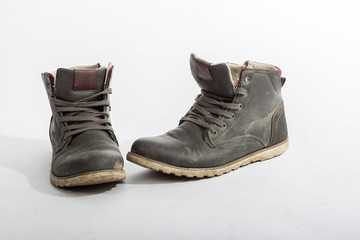 Two old dirty shoes isolated