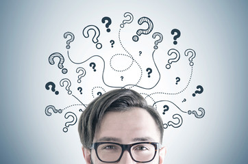 Man in glasses, question marks