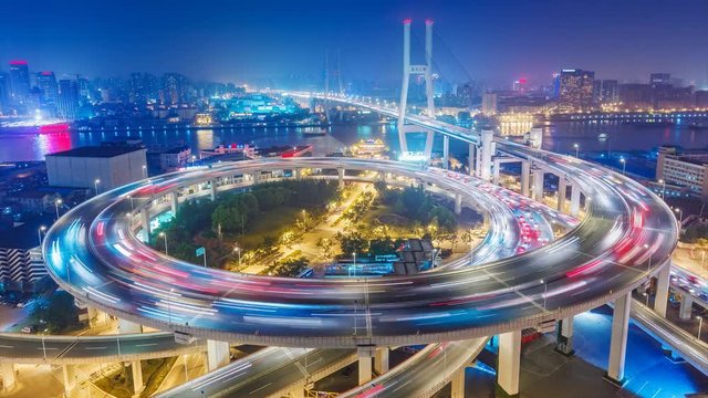 Famous highway intersection in Shanghai, China. Big modern city by night. 4K Time lapse.