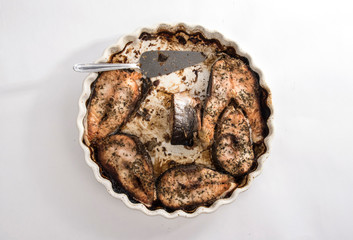 White plate with fish and spatula top view