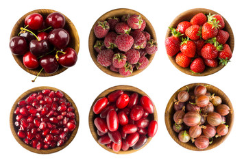 Collage of red fruits and berries isolated on white. Set of strawberries, cherries, raspberries, cornels, gooseberries and pomegranate seeds. Sweet and juicy berry with copy space for text. 