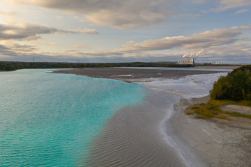 Turquoise water of lake powered by power plant mineral waste. Aerial view.