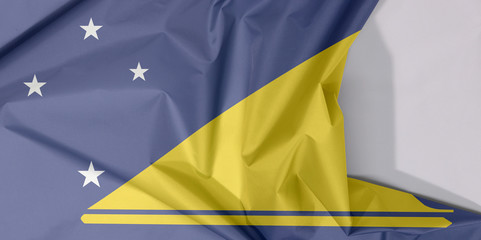 Tokelau fabric flag crepe and crease with white space, A light blue field with the large yellow disk shifted slightly to the hoist-side of center.