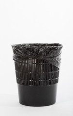 Black office trash can with a package