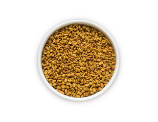 Fenugreek seeds in a wooden bowl isolated on white. Fenugreek seeds isolated on white background. Top view. Fenugreek with copy space for text.