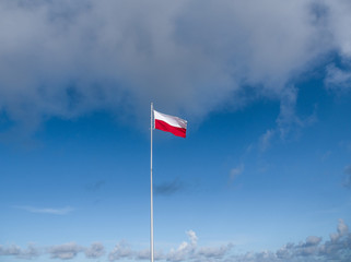 flag of poland in the wind against a sky