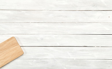 Cutting board top view on wooden background
