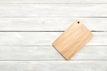 Cutting board top view on wooden background