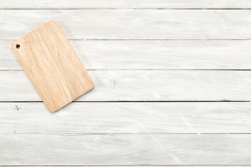 Cutting board top view on wooden background