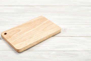 Cutting board top view on wooden background