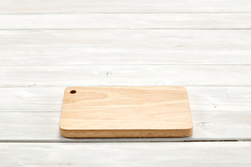Cutting board top view on wooden background