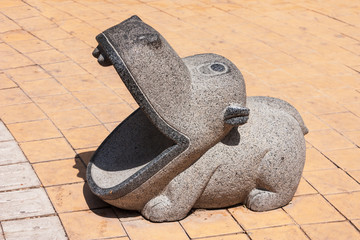Sculpture Behemoth sitting by the fountain in the city Park of Baku, Azerbaijan.