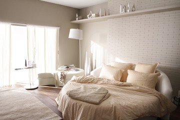 round bed in beige bedroom