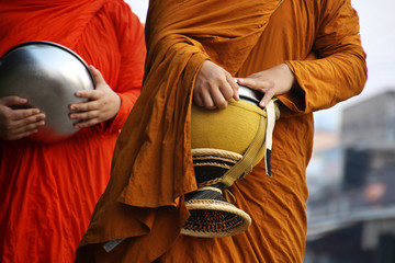 Monks recept  alms in the streets of Luang Prabang, Laos
