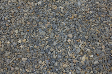 many small multi-colored stones. blue, white and gray stones in one pile