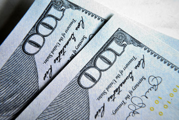 Obraz premium Dolar USA close up. Macro texture of a fragment of the dollar bill. USD banknote texture. One hundred American dollars macro.