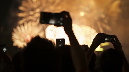 Firework, public, smartphones. Holiday backgrounds. Fireworks in the sky celebrating lunar new year.