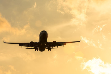 Dark silhouette of an airplane at sunset approach in the airport of a beautiful beautiful sky.