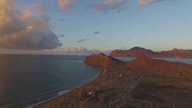 Rocky mountain coast bay aerial view. Shot. Beautiful landscape. Blue clear ocean sea water next to cliff Corfu Greece. Aerial view on beautiful sunset at Greece