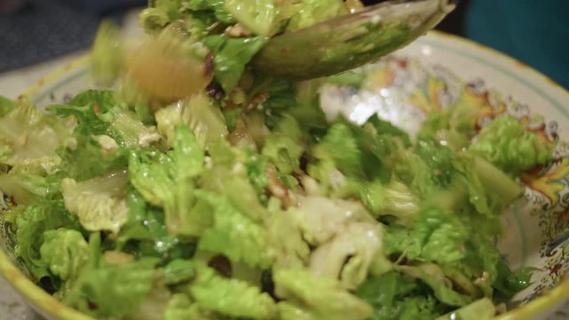 Close Up Salad being Tossed in Bowl with Mixed Ingredients