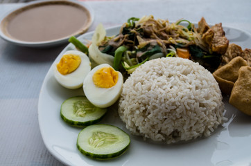 GADO GADO with rice, typical Indonesian salad with hard-boiled eggs, boiled potato, fried tofu and tempeh and peanut sauce.