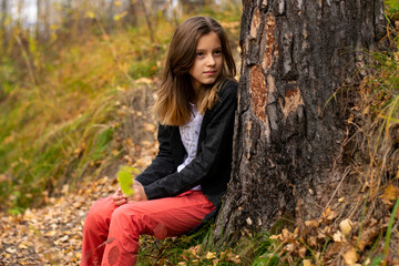 Naklejka na ściany i meble portrait of young woman in autumn park