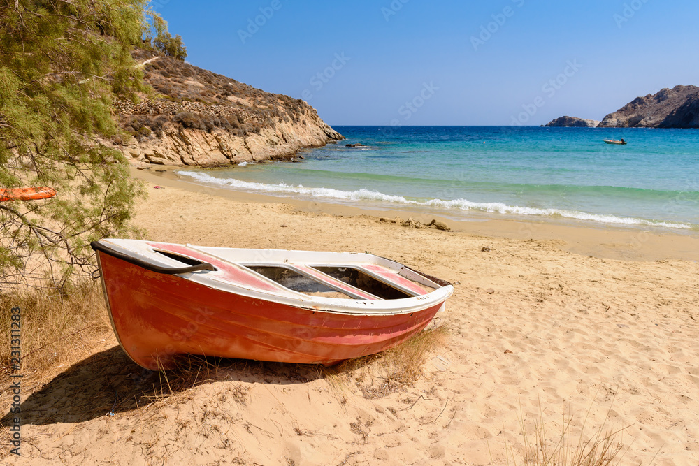 Wall mural boat on psilli ammos beach with soft powder sand and a shallow turquoise bay. serifos island, cyclad