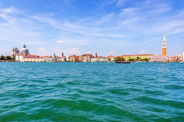 Fototapeta na wymiar View on Venice with St Mark's Campanile and the Dome of Santa Maria della Salute from the lagoon