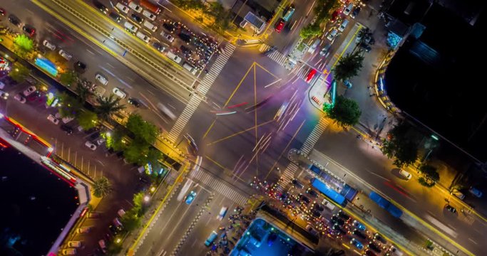 JAKARTA, Indonesia - October 31, 2018: Beautiful aerial hyperlapse of night traffic on the road intersection in Jakarta downtown, Indonesia. Shot in 4k resolution