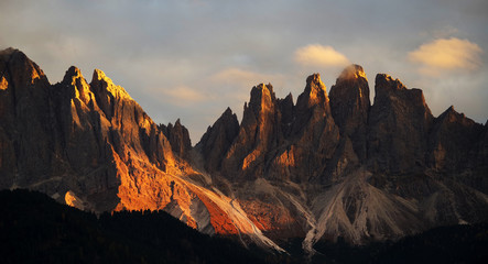 Fototapeta na wymiar Beautiful idyllic mountain scenery in the Dolomites in golden evening light at sunset in fall colours, Val di Funes, South Tyrol, northern Italy