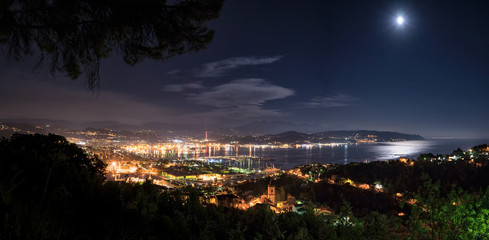 Panorama of the full moon over the port city of La Spezia in Liguria, Italy