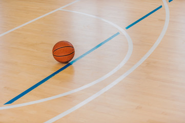 Basketball ball over floor in the gym