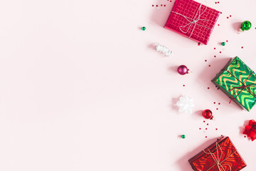 Christmas composition. Christmas gifts, decorations on pastel pink background. Flat lay, top view,...