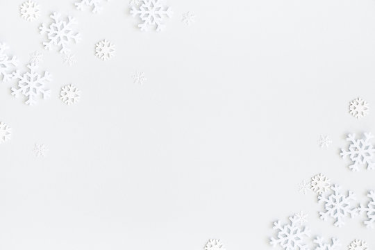 Christmas composition. Christmas frame made of snowflakes on pastel gray background. Winter concept. Flat lay, top view, copy space