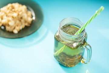 oatmeal with apple slices, herbs tea, on a blue background, the light from the window