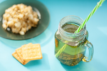 oatmeal with apple slices, herbs tea, on a blue background, the light from the window