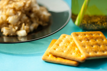 oatmeal with apple slices, herbs tea, on a blue background, the light from the window