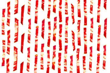 Background of vertical cut strips of smoked sausage, isolated on white background.