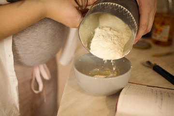 pregnant cook in the kitchen of flour