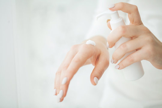 Hand Skin Care. Close Up Of Female Hands Holding Cream Tube, Beautiful Woman Hands With Natural Manicure Nails Applying Cosmetic Hand Cream On Soft Silky Healthy Skin