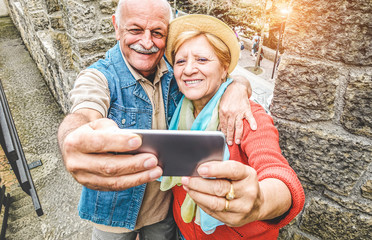 Senior couple taking a selfie inside castle on tour vacation