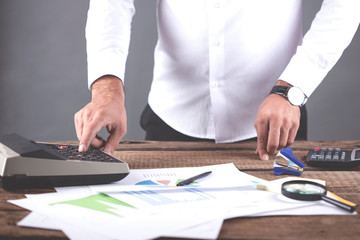man hand graph with calculator on table